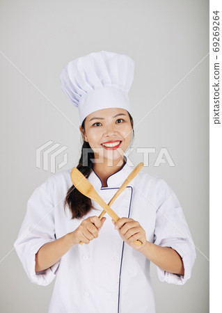 Pretty smiling young Asian cook Pretty smiling young Asian cook 69269264