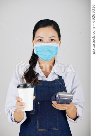 Barista giving payment terminal and order Barista giving payment terminal and order 69269316