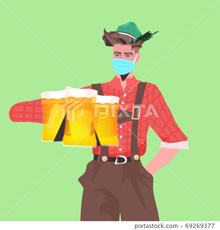 man in medical mask holding beer mugs Oktoberfest party celebration coronavirus quarantine concept 69269377