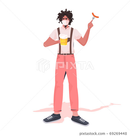 man in medical mask holding beer mug and sausage Oktoberfest party celebration coronavirus quarantine 69269448