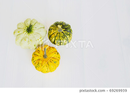 Colorful mini pumpkins of different colors on white background. Colorful mini pumpkins of different colors on white background. 69269939