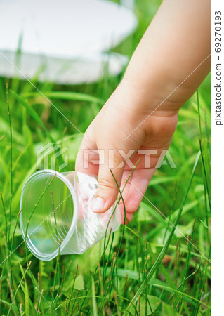 Little girl cleans plastic utensils 69270193