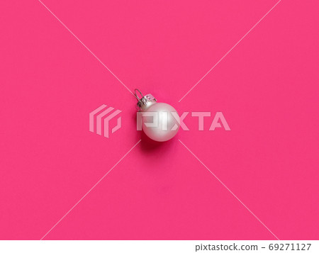 Silver Christmas bauble on a pink background 69271127