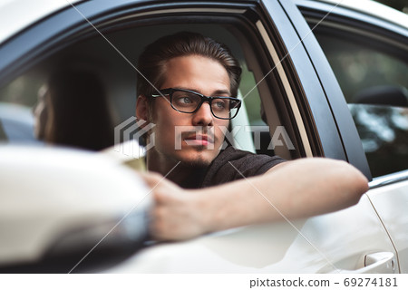 Close up side portrait of caucasian man driving Close up side portrait of caucasian man driving 69274181