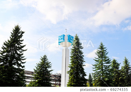 Unusual clock on a background of a white-blue sky Unusual clock on a background of a white-blue sky 69274335