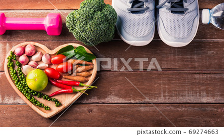 fruit and vegetable in heart plate and sports shoes, dumbbell an 69274663