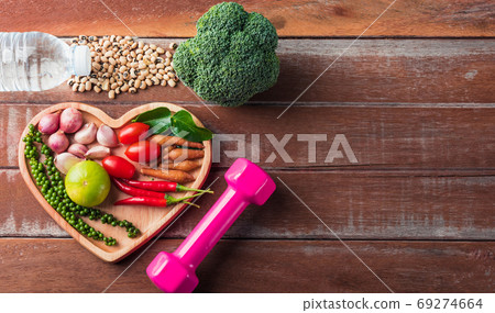 fruit and vegetable in heart plate and sports shoes, dumbbell an fruit and vegetable in heart plate and sports shoes, dumbbell an 69274664