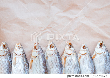 Dried fishes template banner on craft paper background with empty space for text. Flat Salted roach web cover backdrop. Seafood snack poster, flyer decorative design. Fish frame for promotion shop 69274674