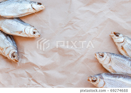 Dried fishes template banner on craft paper background with empty space for text. Flat Salted roach web cover backdrop. Seafood snack poster, flyer decorative design. Fish frame for promotion shop 69274688