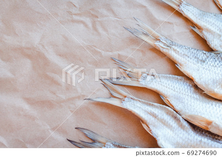 Dried fishes template banner on craft paper background with empty space for text. Flat Salted roach web cover backdrop. Seafood snack poster, flyer decorative design. Fish frame for promotion shop Dried fishes template banner on craft paper background with empty space for text. Flat Salted roach web cover backdrop. Seafood snack poster, flyer decorative design. Fish frame for promotion shop 69274690