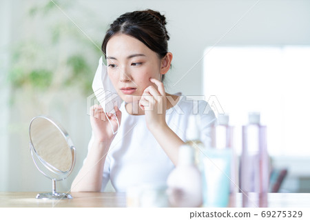 Young woman worries about rough skin due to mask 69275329