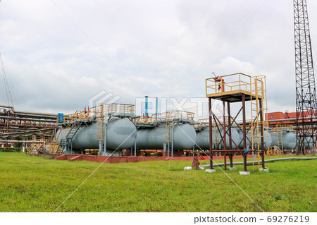 Large iron tanks, ladders and protective fencing Large iron tanks, ladders and protective fencing 69276219