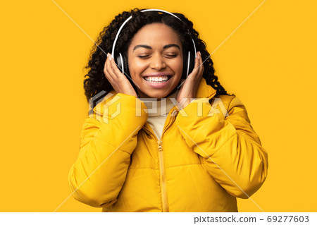 African Girl Listening Song Enjoying Sound In Headphones In Studio African Girl Listening Song Enjoying Sound In Headphones In Studio 69277603