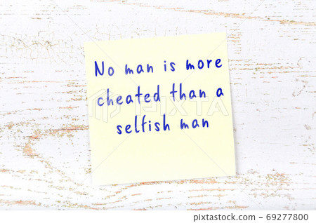 Yellow sticky note on wooden wall with wise quote Yellow sticky note on wooden wall with wise quote 69277800