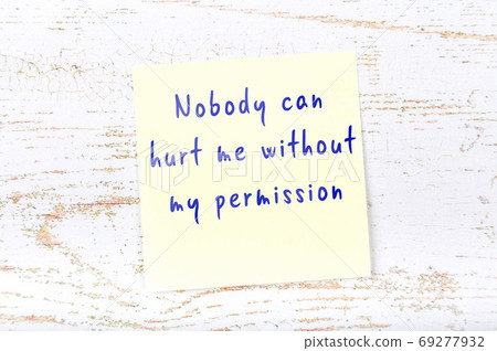 Yellow sticky note on wooden wall with wise quote Yellow sticky note on wooden wall with wise quote 69277932