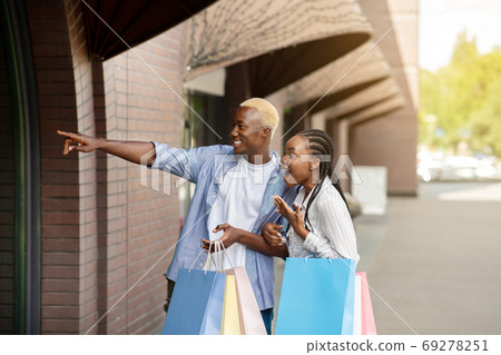 Amazing selling out. Shocked african american boy and girl looks in shop window 69278251