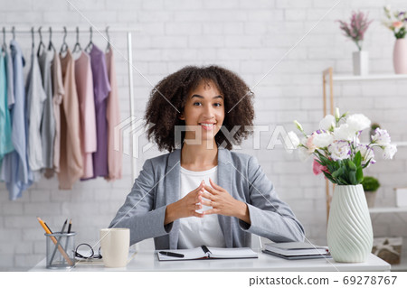 Video call and conference with designer. Cheerful african american woman looking at camera 69278767