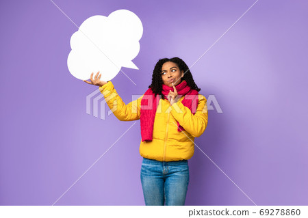 Thoughtful Black Girl Holding Speech Bubble Above Head In Studio 69278860