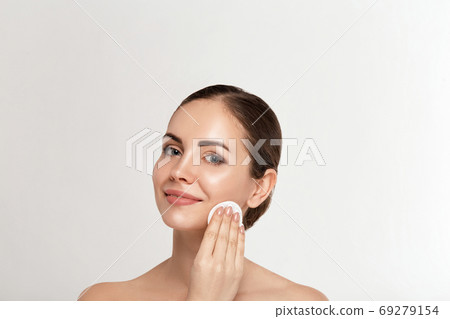 Woman Cleaning Face With White Pad. Woman Cleaning Face With White Pad. 69279154