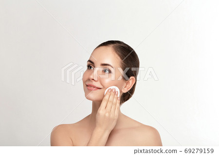 Woman Cleaning Face With White Pad. Woman Cleaning Face With White Pad. 69279159