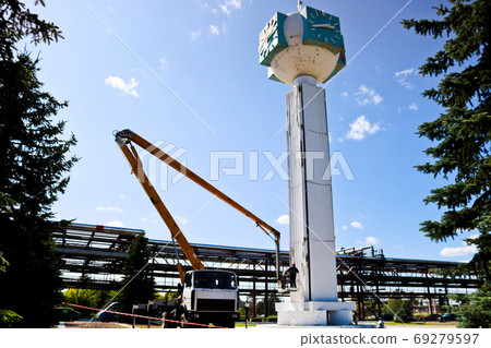 Repair of the tower clock. Workers on the crane Repair of the tower clock. Workers on the crane 69279597