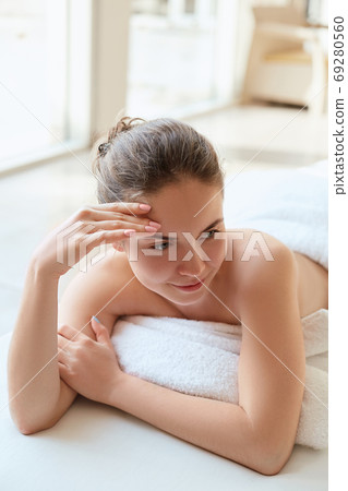 Massaging tired muscles. Close-up of massage therapist massaging beautiful female leg. Massaging tired muscles. Close-up of massage therapist massaging beautiful female leg. 69280560