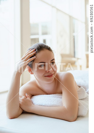 Massaging tired muscles. Close-up of massage therapist massaging beautiful female leg. Massaging tired muscles. Close-up of massage therapist massaging beautiful female leg. 69280561