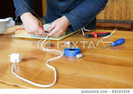 A man working electrician works, collects A man working electrician works, collects 69281956