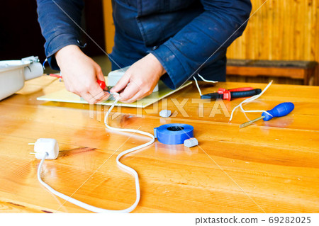 A man working electrician works, collects A man working electrician works, collects 69282025