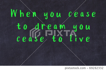 Chalk inscription of smart quote on black desk 69282332