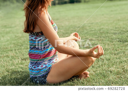 Hand of a woman meditating in a yoga pose. Meditation. Active Lifestyle. Beauty woman doing yoga Hand of a woman meditating in a yoga pose. Meditation. Active Lifestyle. Beauty woman doing yoga 69282728