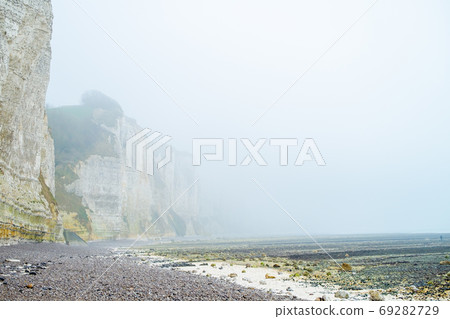 Misty morning fog landscape on the cliffs of Etretat in France Misty morning fog landscape on the cliffs of Etretat in France 69282729