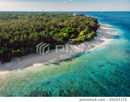 Tropical beach at island with trees and turquoise ocean. Aerial view. Paradise place 69283135
