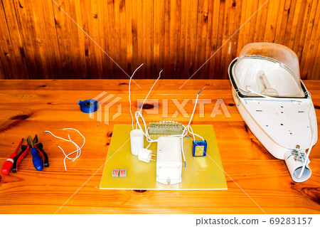 A large white disassembled street lamp A large white disassembled street lamp 69283157