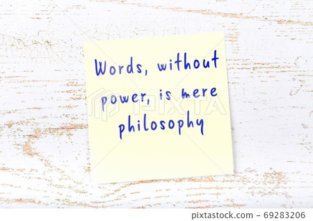 Yellow sticky note on wooden wall with wise quote Yellow sticky note on wooden wall with wise quote 69283206