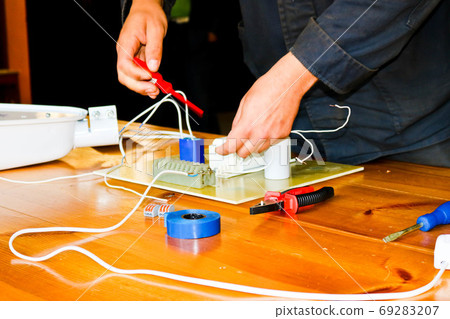 A man working electrician works, collects A man working electrician works, collects 69283207