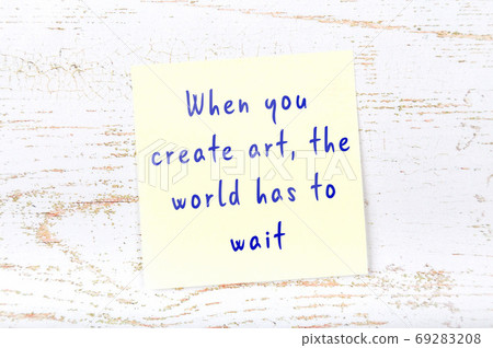 Wise quote on sticky note on wooden wall Wise quote on sticky note on wooden wall 69283208