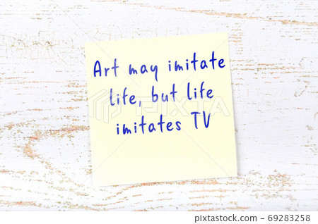 Yellow sticky note on wooden wall with wise quote 69283258