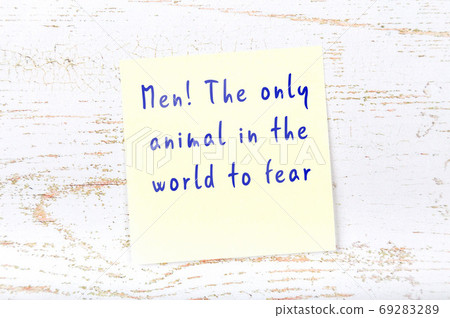 Yellow sticky note on wooden wall with wise quote 69283289