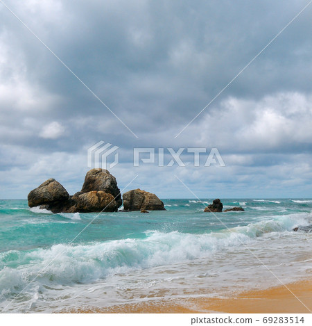 Beautiful sea scape. Sandy beach and boulders. Beautiful sea scape. Sandy beach and boulders. 69283514