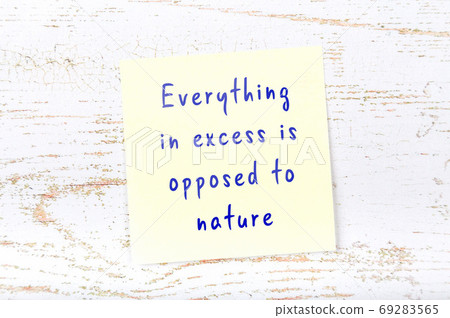 Yellow sticky note on wooden wall with wise quote 69283565