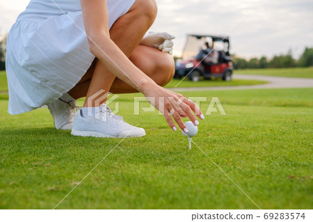 Woman Hands Place Ball On Golf Pin . Woman Hands Place Ball On Golf Pin . 69283574