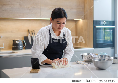 Female Kneads Dough On Floured Table. Female Kneads Dough On Floured Table. 69283640