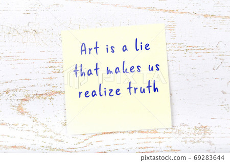 Wise quote on sticky note on wooden wall Wise quote on sticky note on wooden wall 69283644