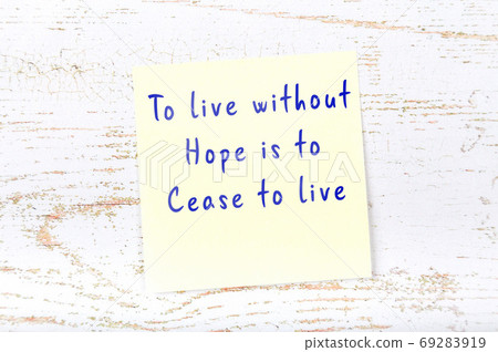 Wise quote on sticky note on wooden wall  69283919