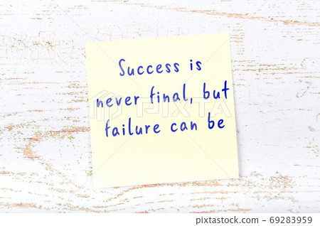 Yellow sticky note on wooden wall with wise quote 69283959