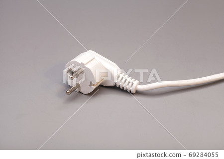 White plug isolated on gray background White plug isolated on gray background 69284055