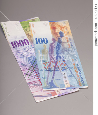 Swiss 1000 and 100 Franc notes isolated on gray Swiss 1000 and 100 Franc notes isolated on gray 69284134