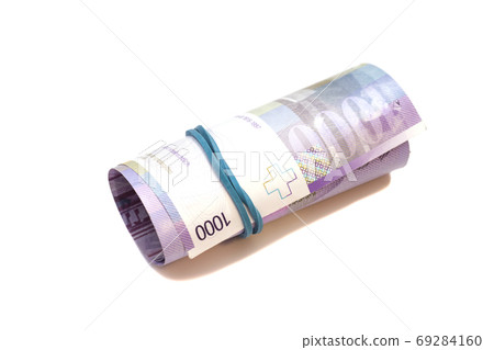 Swiss thousand francs in a roll on white background 69284160