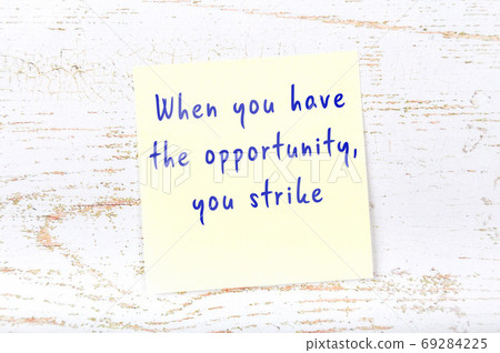 Wise quote on sticky note on wooden wall  69284225